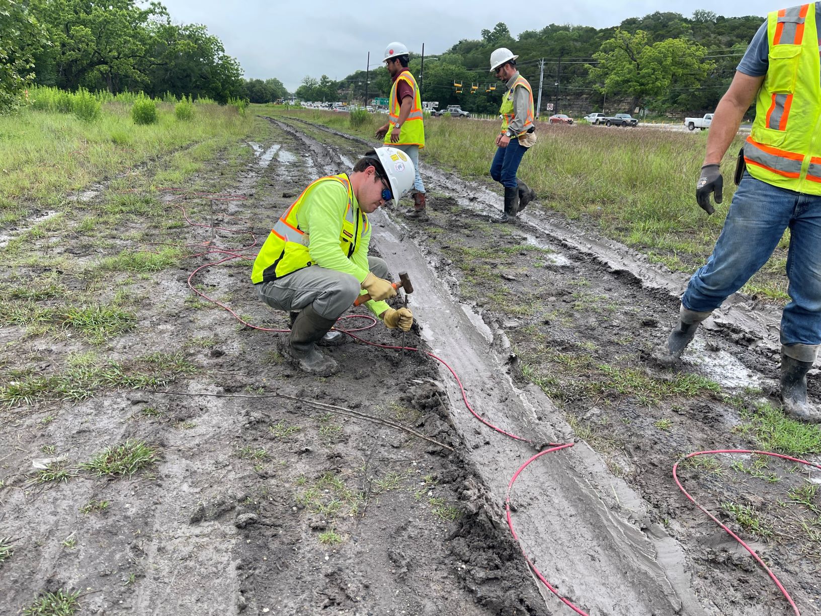 Crews strategically place direct-current electrical resistivity imaging (DC-ERI) sensors along the future footprint of a bridge near US 290 and Old Bee Caves Road, May 2021